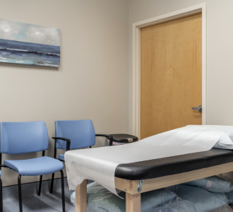 An exam table and chairs