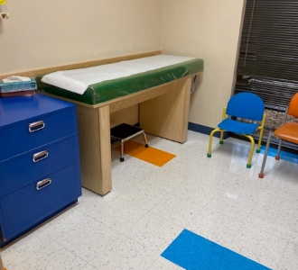 A medical table and drawers in an exam room