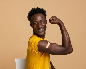 A patient flexing their arm after receiving a flu shot