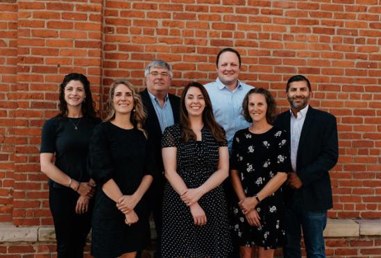 A group photo of the providers beside a building